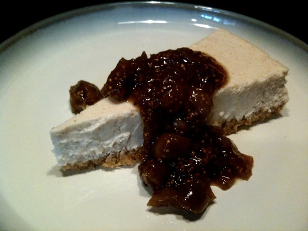 Greek Yogurt Cheesecake slice covered in Ouzo-Poached Figs