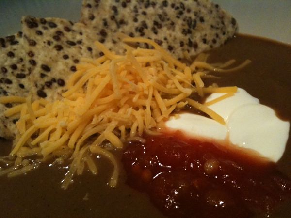 Spicy Black Bean soup with salsa, sour cream, cheddar cheese and chips